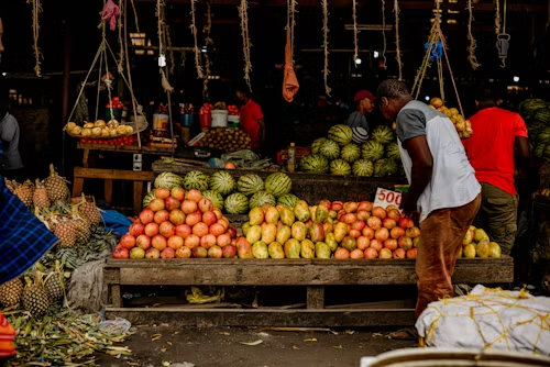Fruit market stall with watermelons and apples